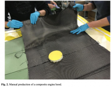 Fig. 2. Manual production of a composite engine hood.